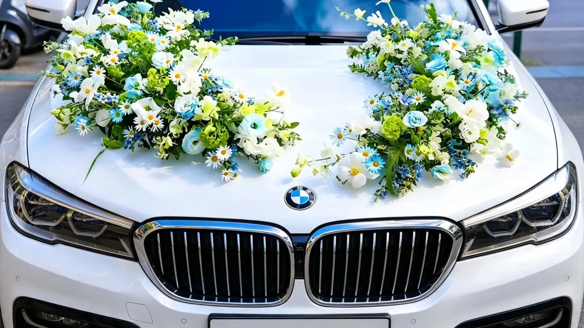 Zweiteiliger blau-weißer Blumenschmuck auf einer weißen Motorhaube